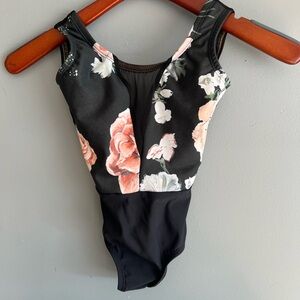 Lucky Leo leotard with floral print on black with a mesh V-cut at the chest